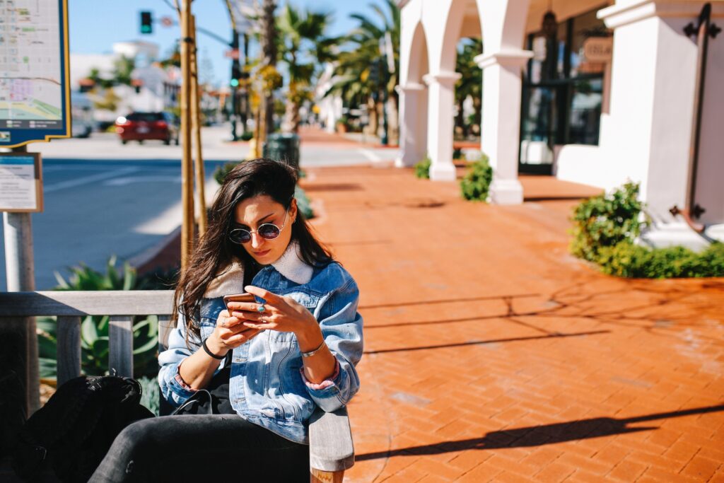 Young woman checking her smartphone in Santa Barbara, California