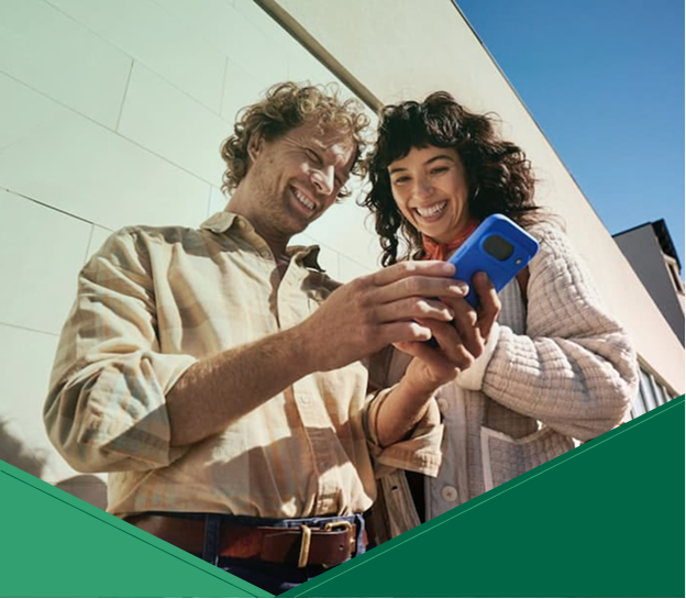 Two people looking at a mobile phone together